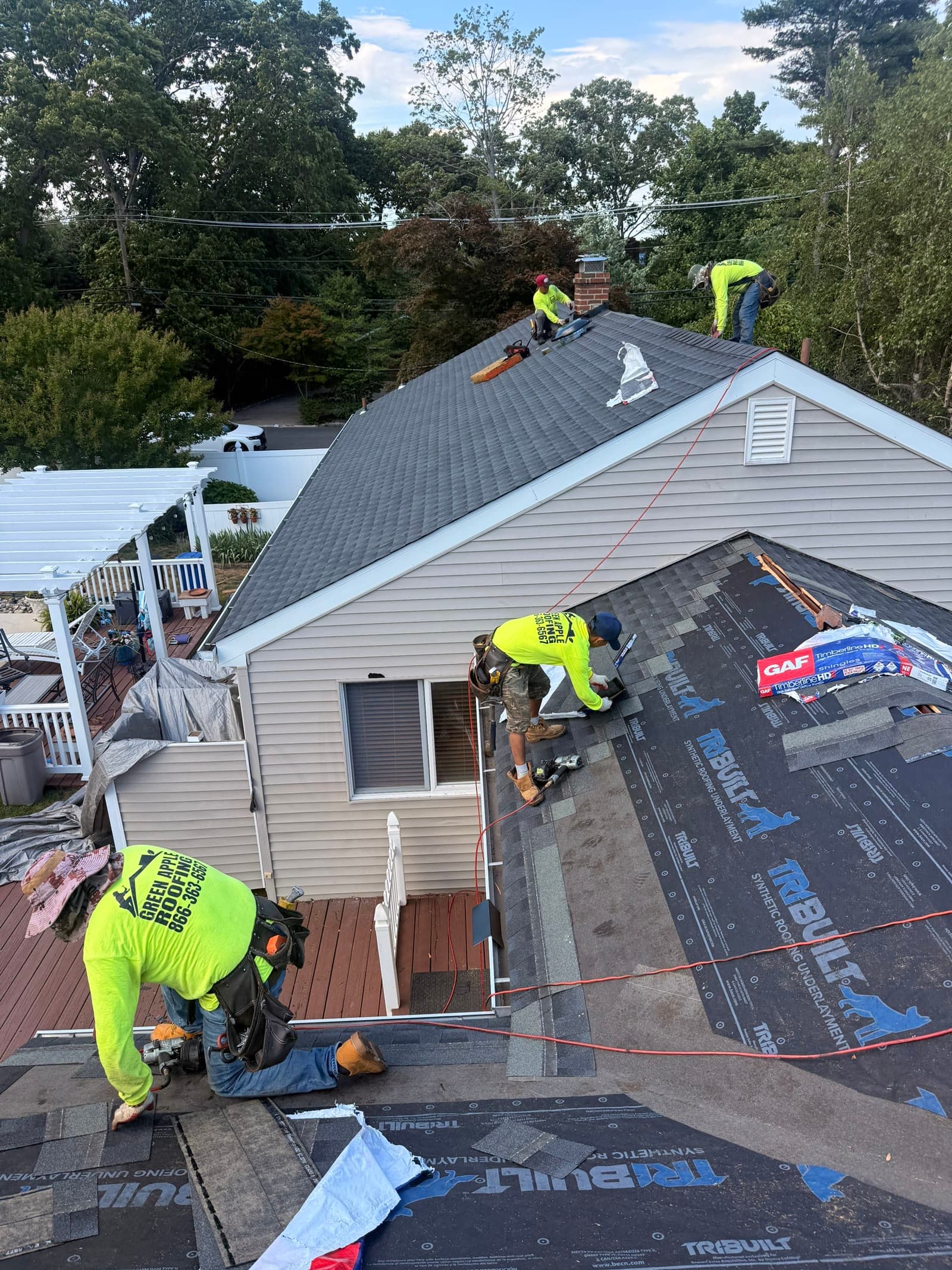 Crew installing shingles on ranch home — Green Apple Roofing, New Jersey