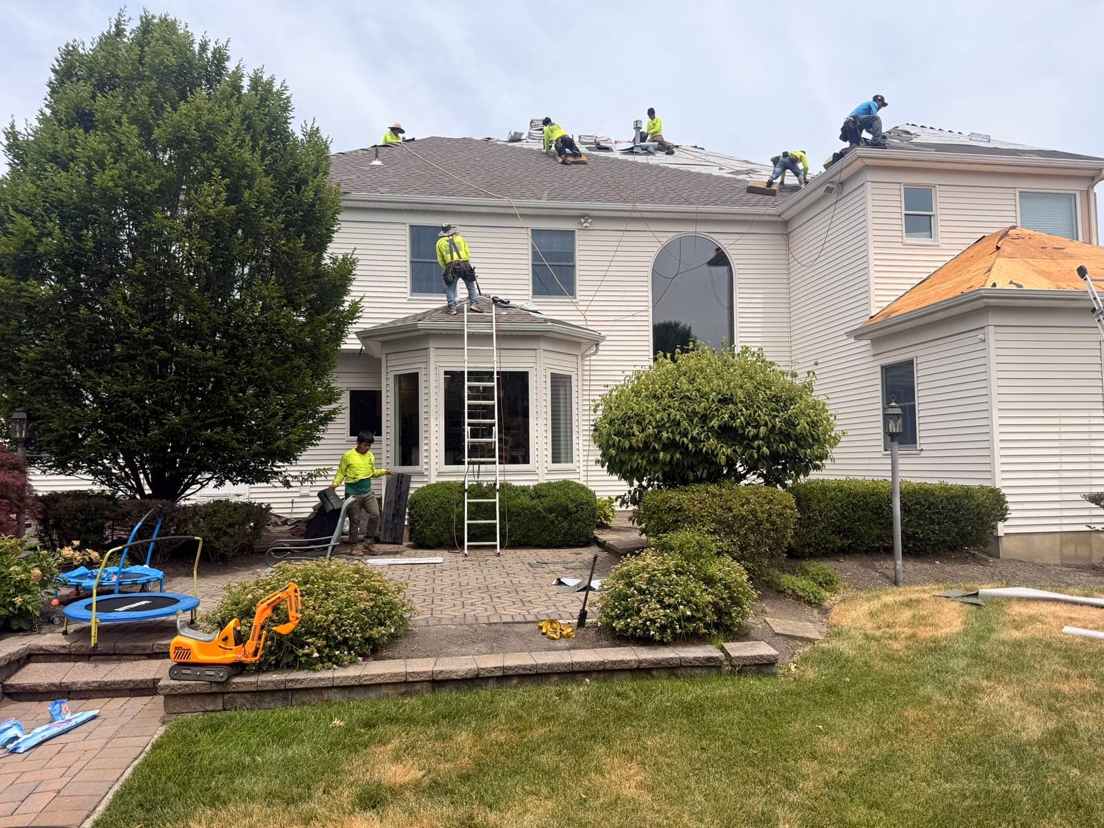 Crew tearing off roof on large colonial — Green Apple Roofing, New Jersey