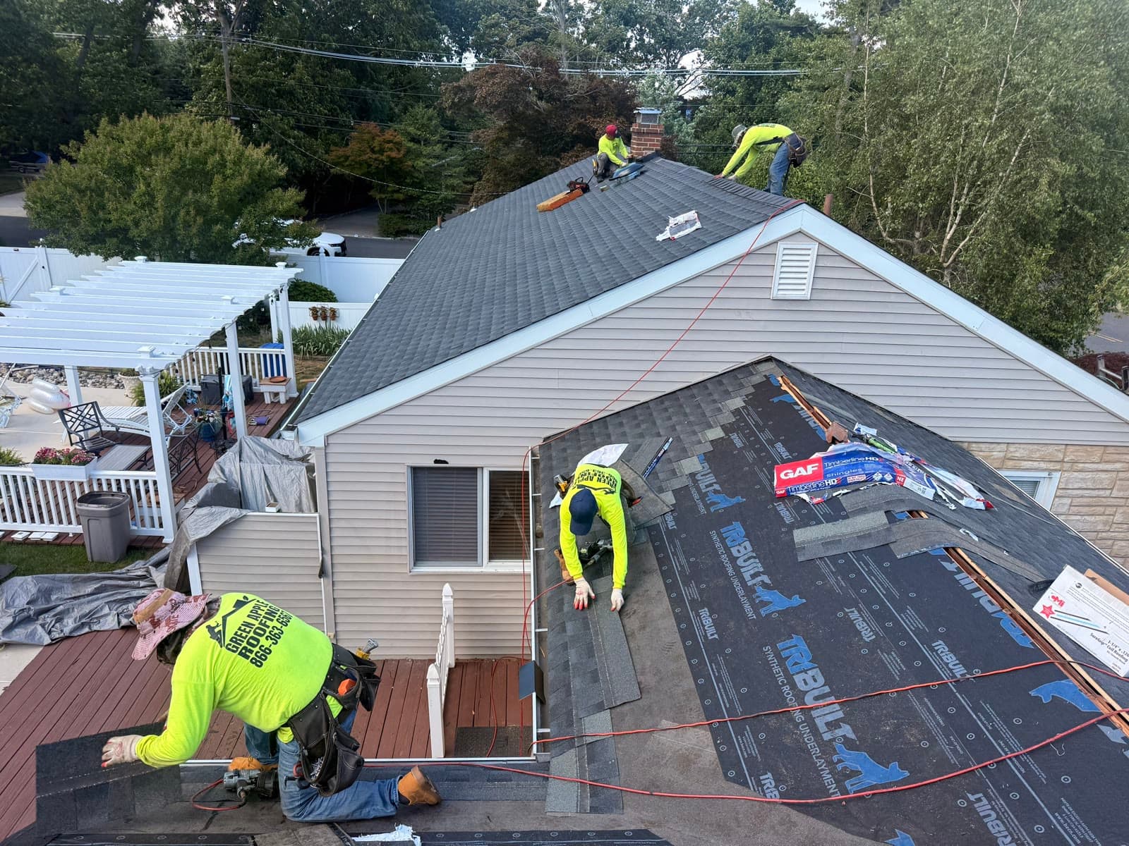 Drone view of crew installing shingles — Green Apple Roofing, New Jersey