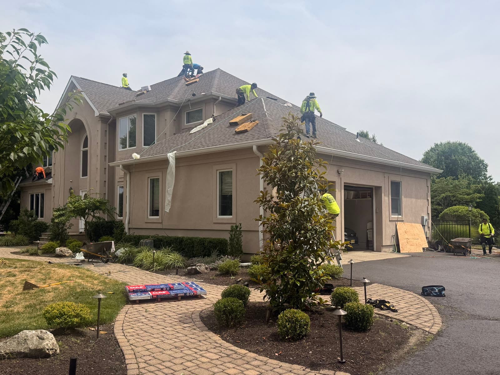 Crew re-roofing stucco home, fresh decking — Green Apple Roofing, New Jersey