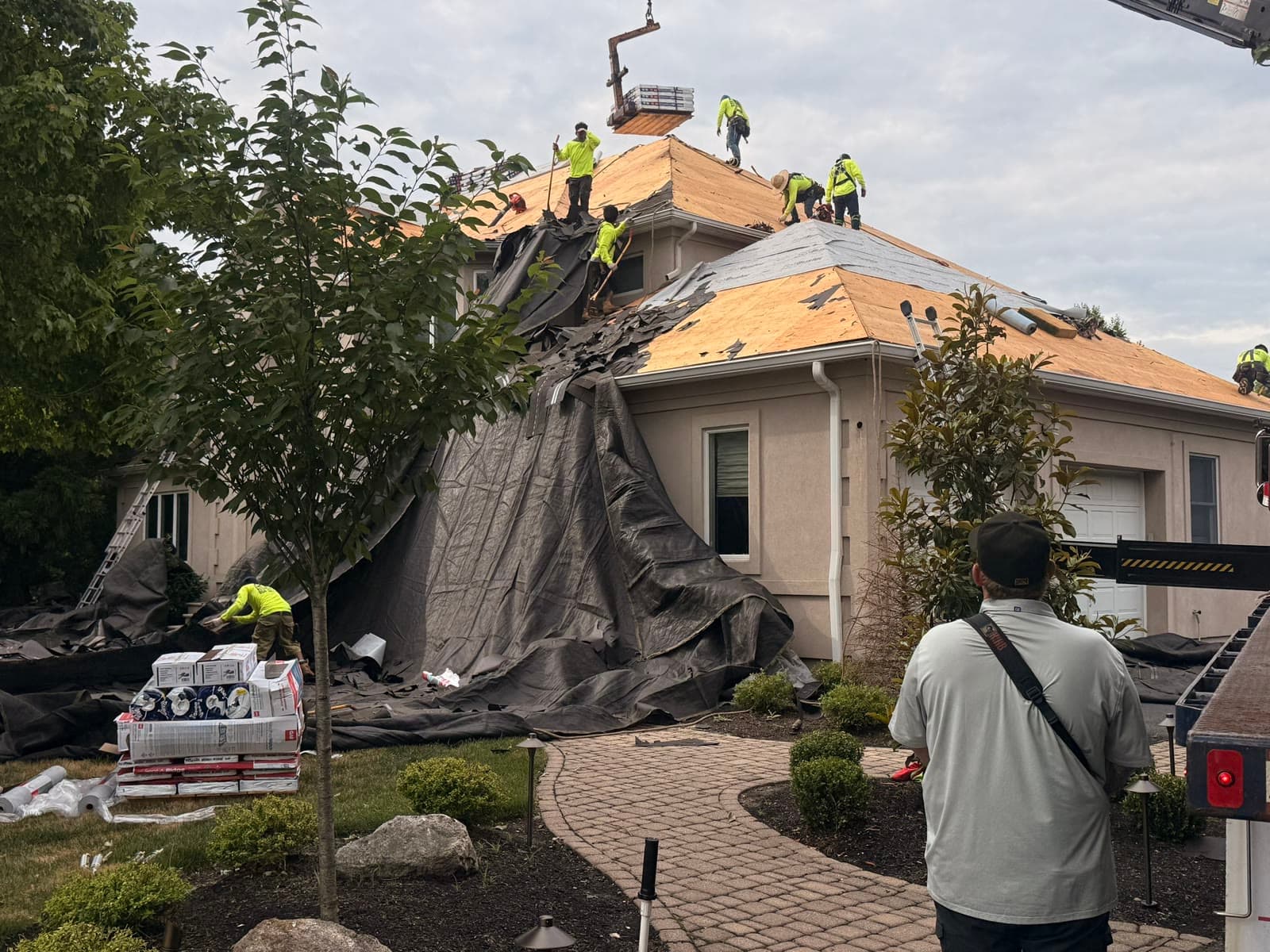 Full crew re-decking roof, landscaping tarped — Green Apple Roofing, New Jersey