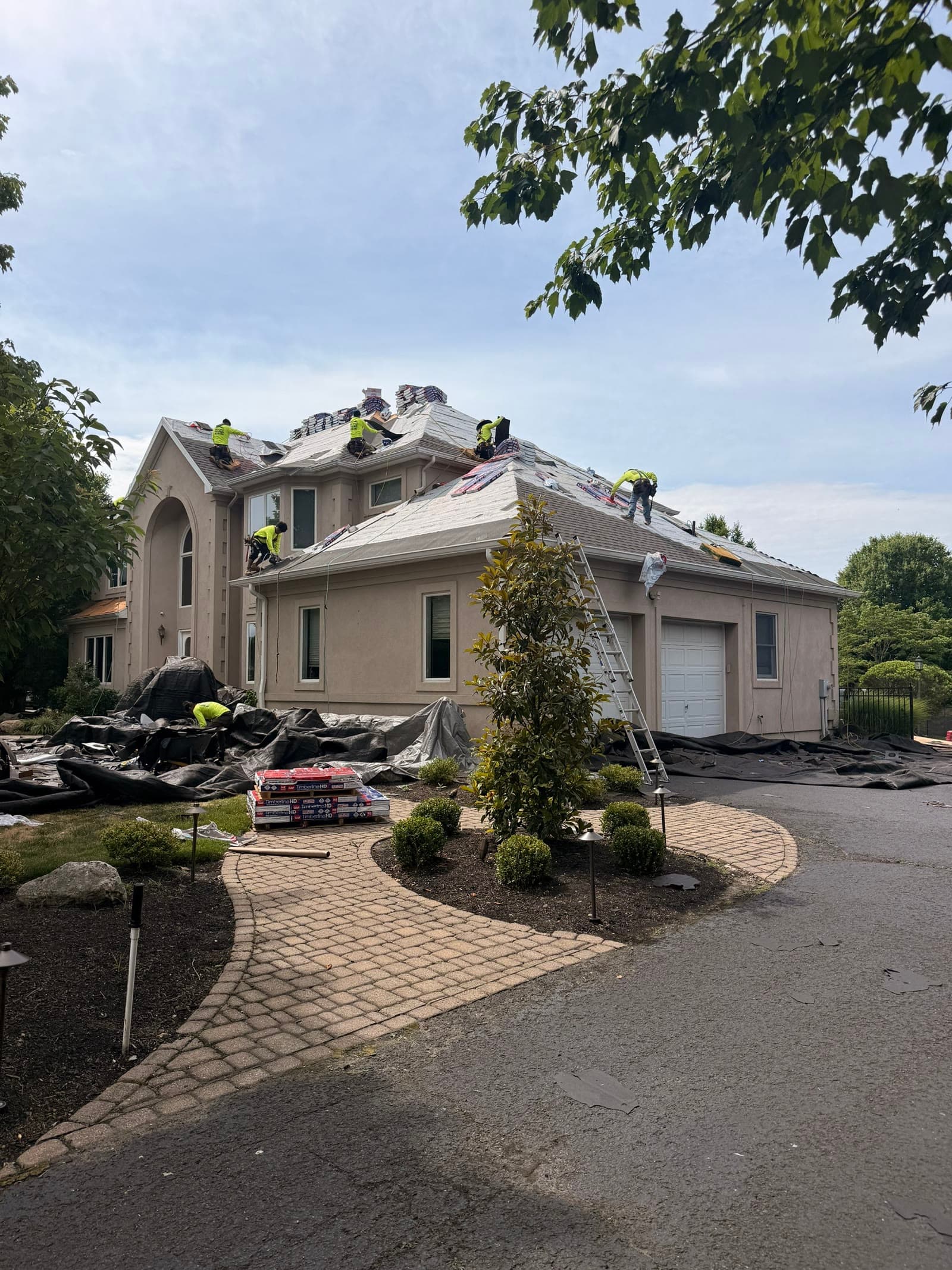 Large home tarped, crew, paver drive — Green Apple Roofing, New Jersey