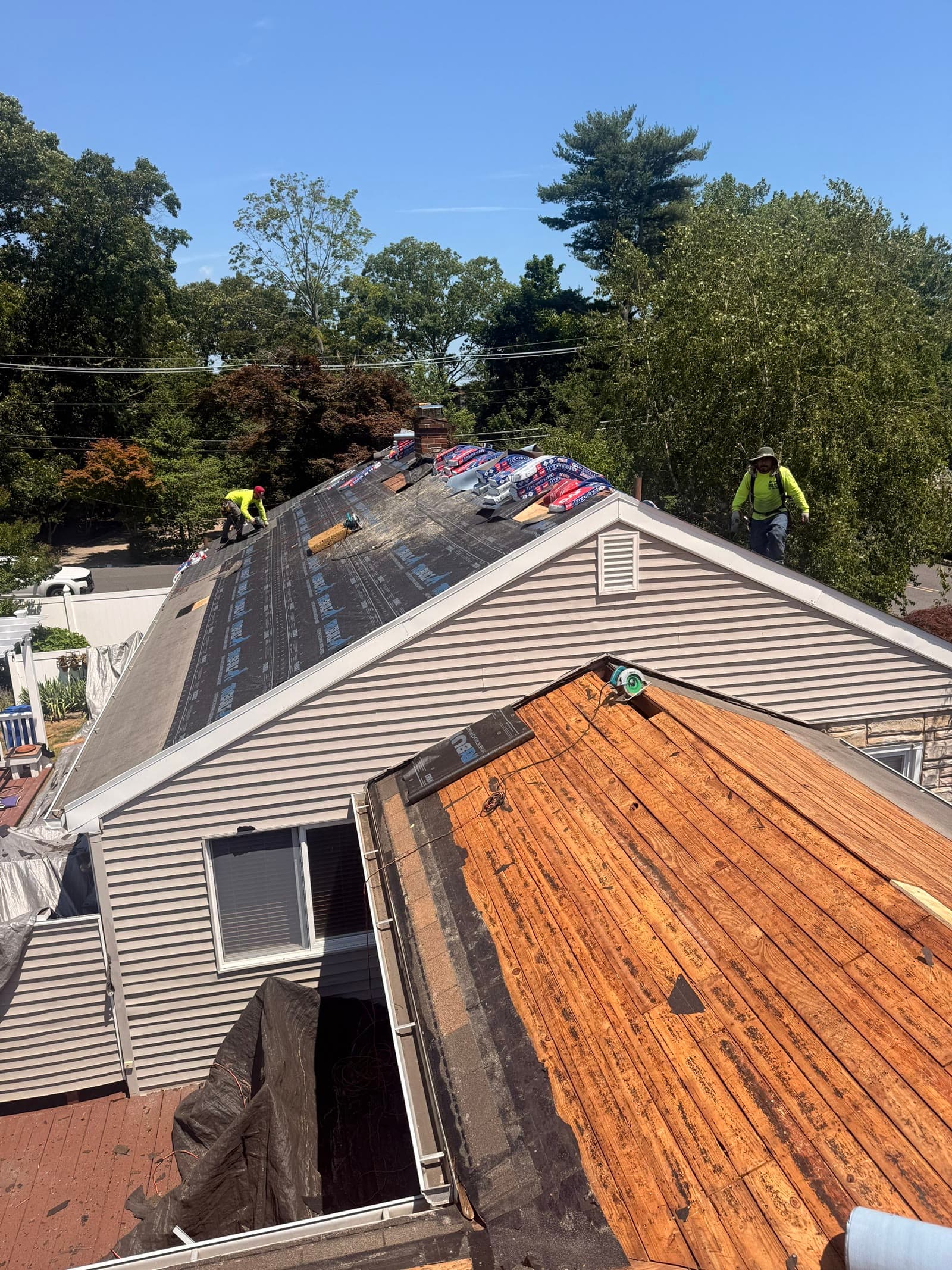 Crew on roof, exposed decking layers — Green Apple Roofing, New Jersey
