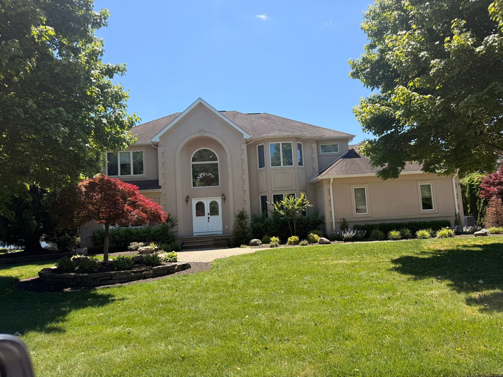 Beige stucco home, finished roof, lawn — Green Apple Roofing, New Jersey