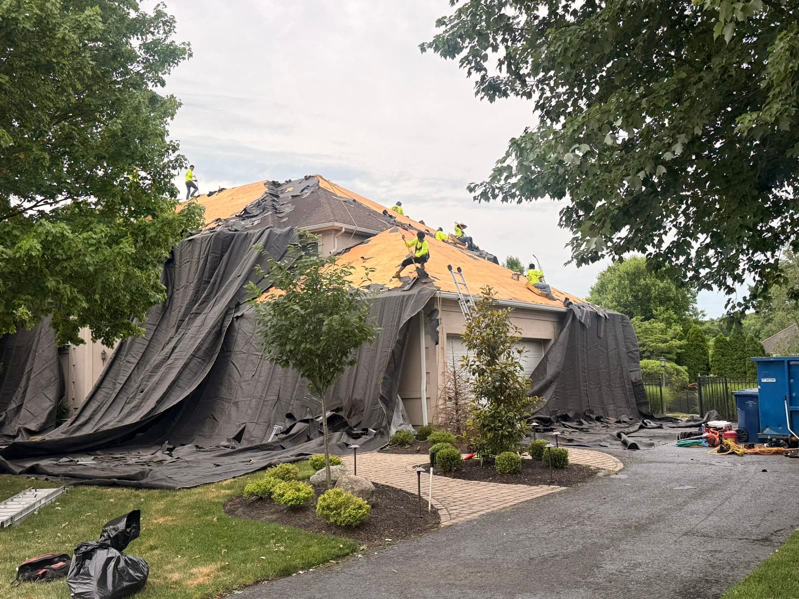 Whole-house tarped tear-off, crew on deck — Green Apple Roofing, New Jersey