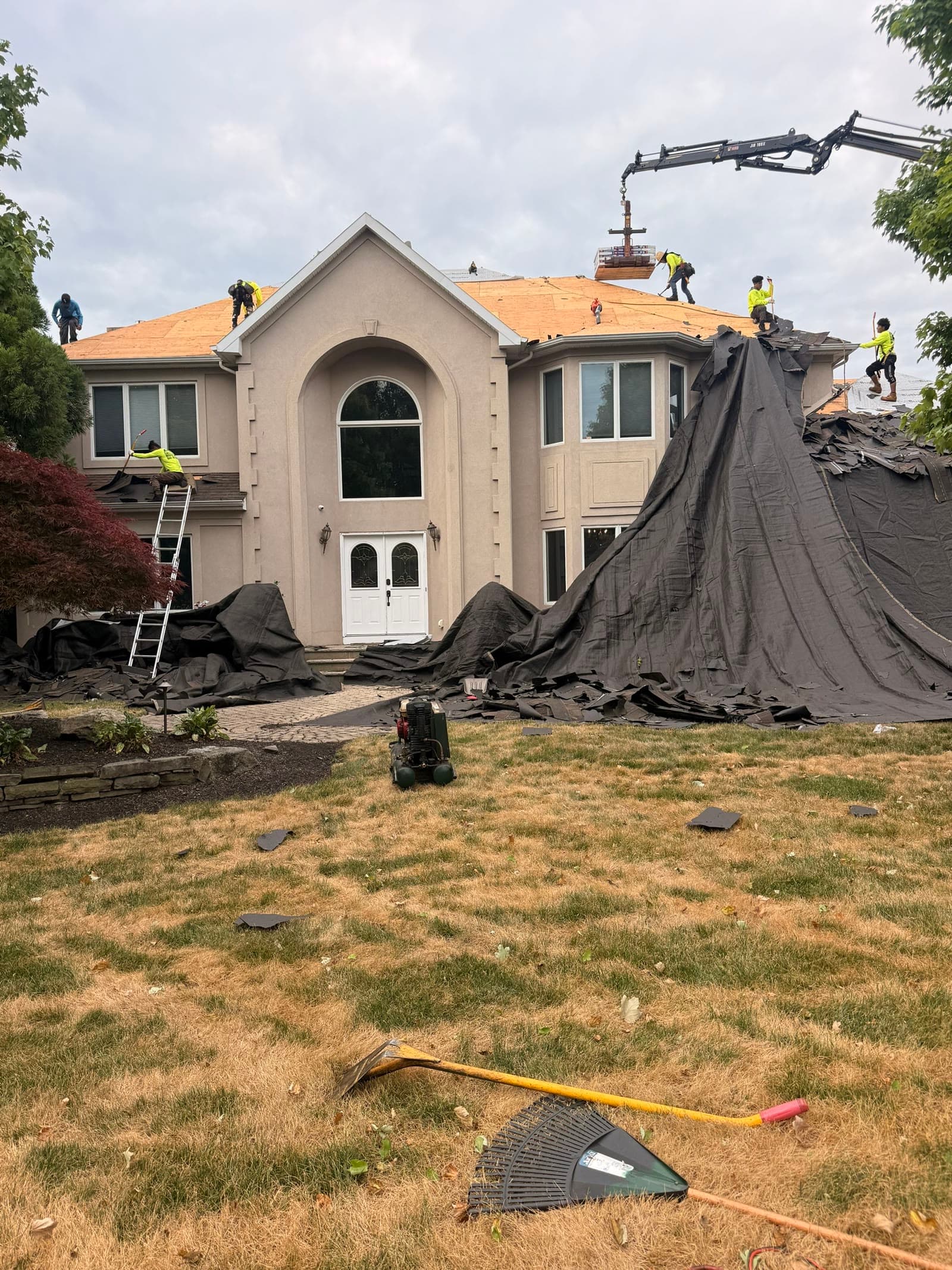 Crane lifts old roofing, crew on roof — Green Apple Roofing, New Jersey
