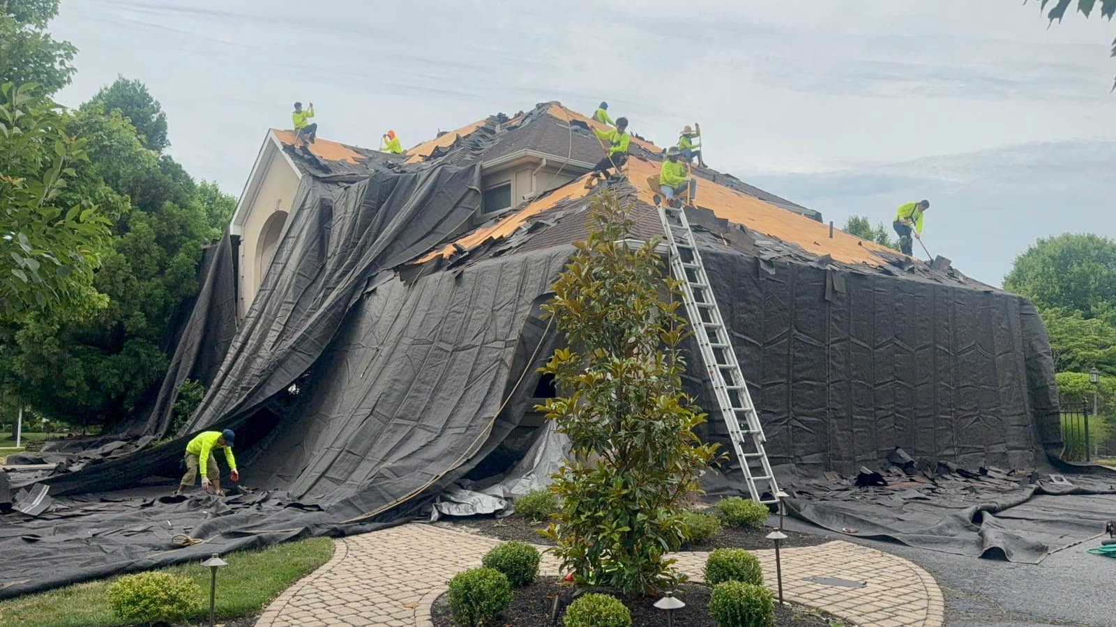 Crew tear-off, felt cascading down facade — Green Apple Roofing, New Jersey