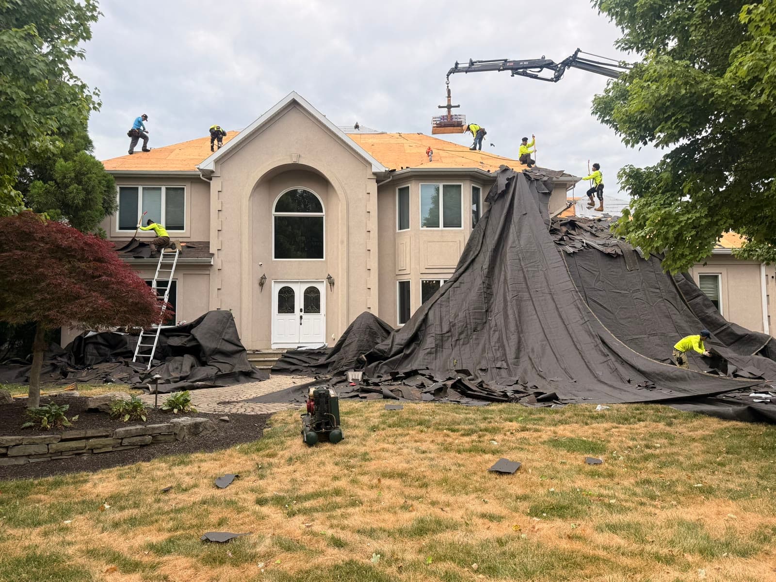Crane and crew tearing off stucco home — Green Apple Roofing, New Jersey