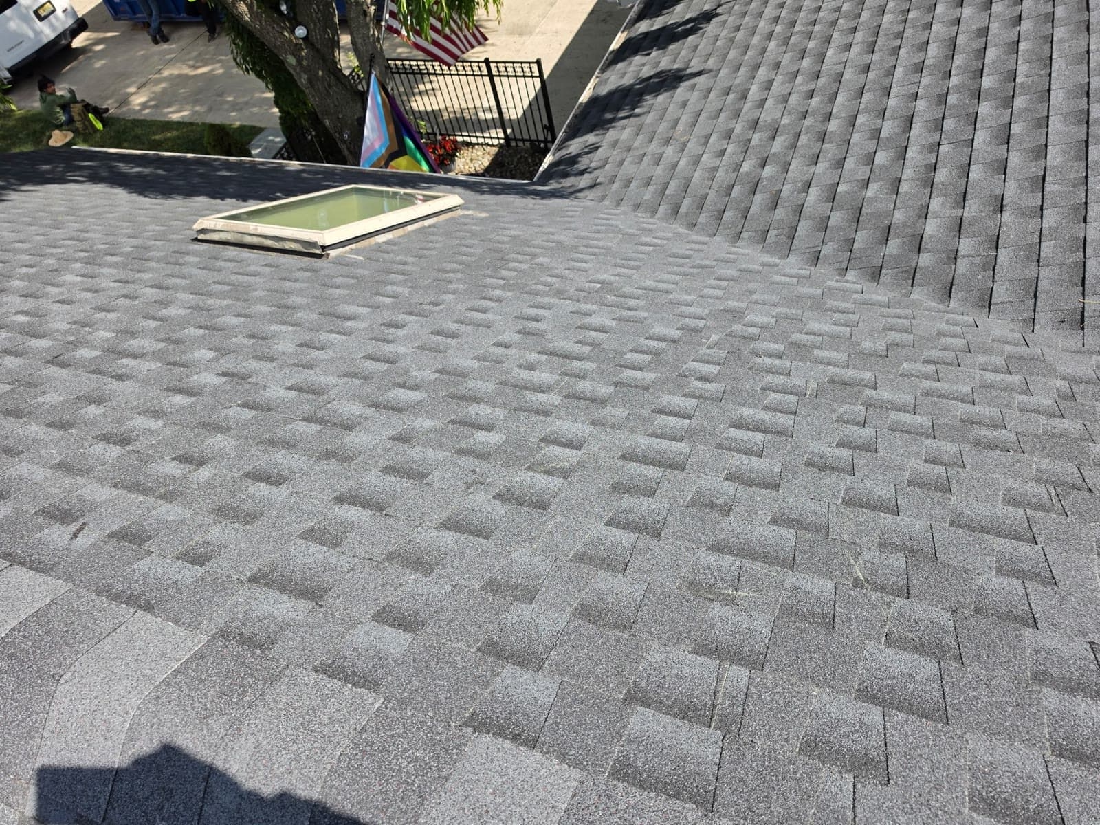 A skylight on a new gray shingle roof — Green Apple Roofing, New Jersey