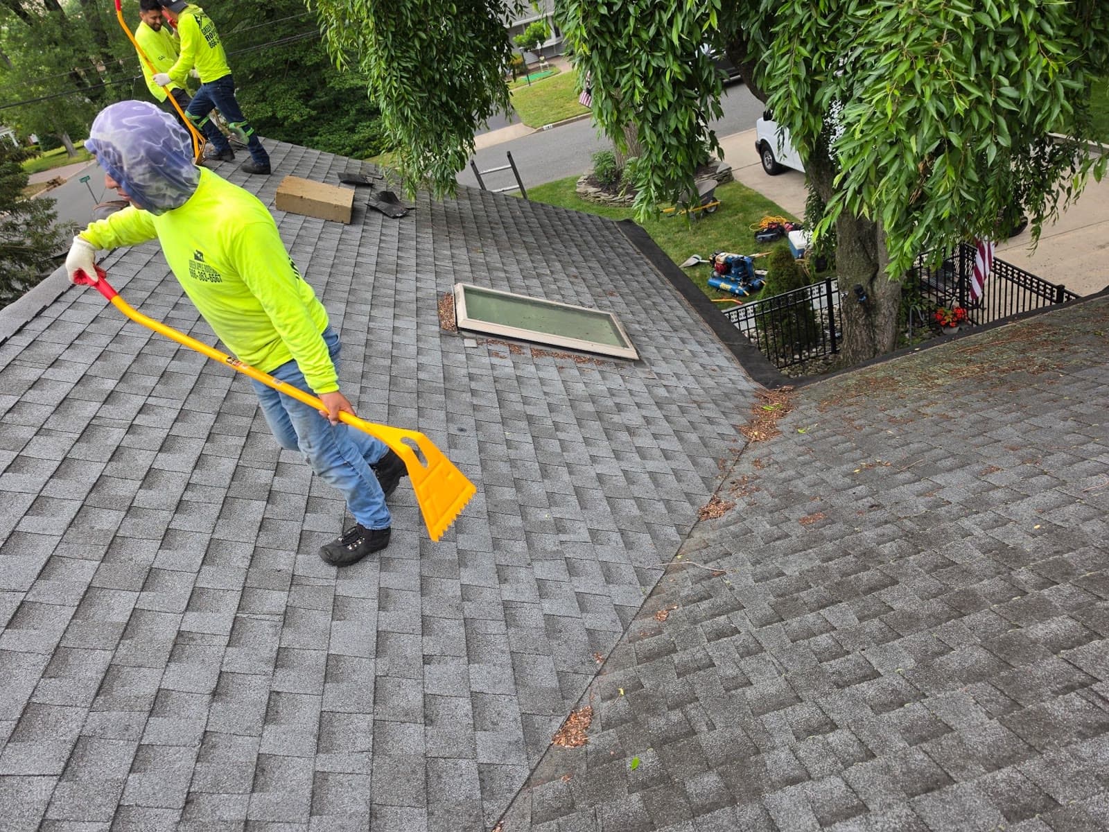 A worker finishing a new roof with a skylight — Green Apple Roofing, New Jersey