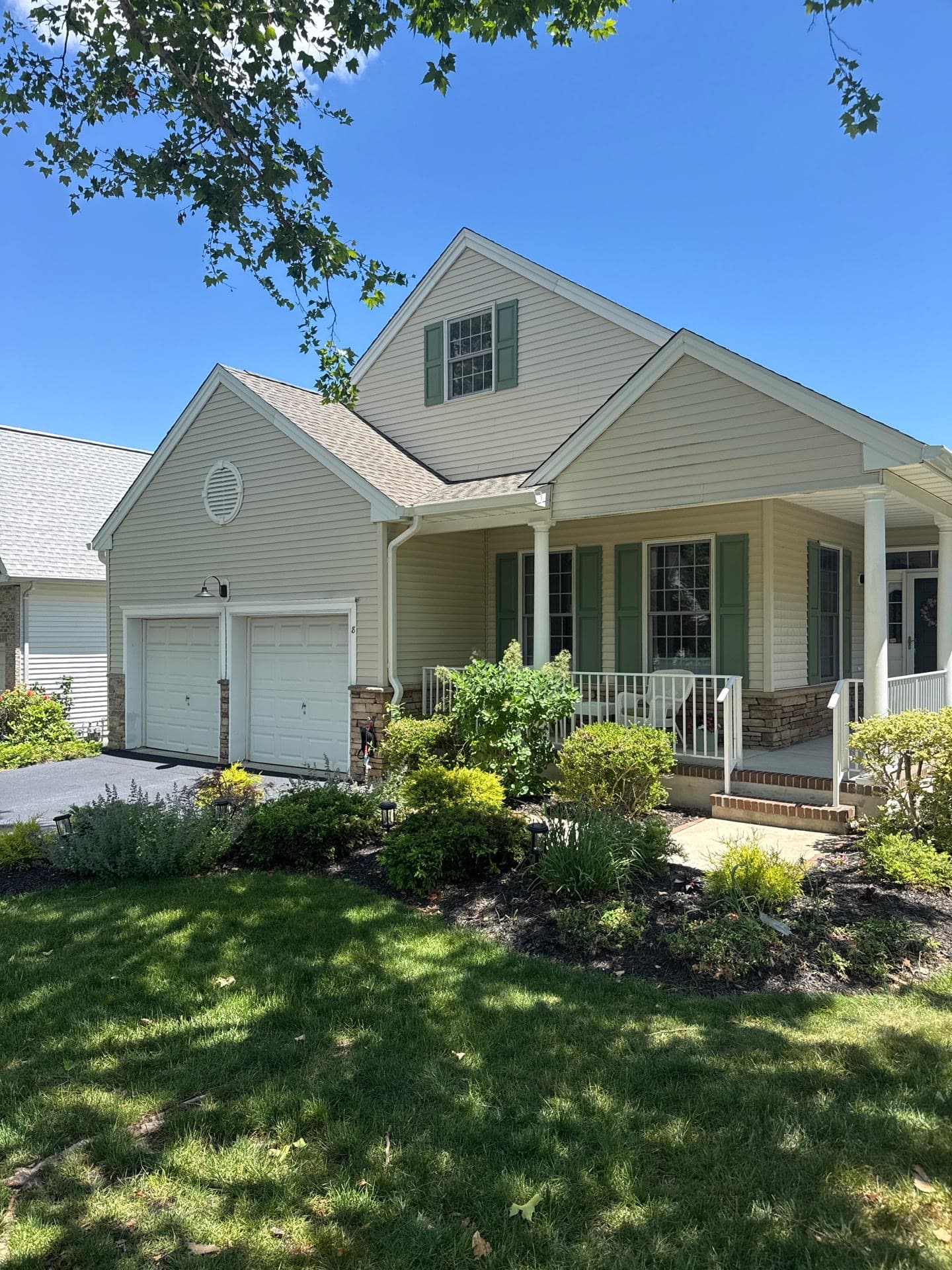 Tan home with a new roof and landscaped front — Green Apple Roofing, New Jersey