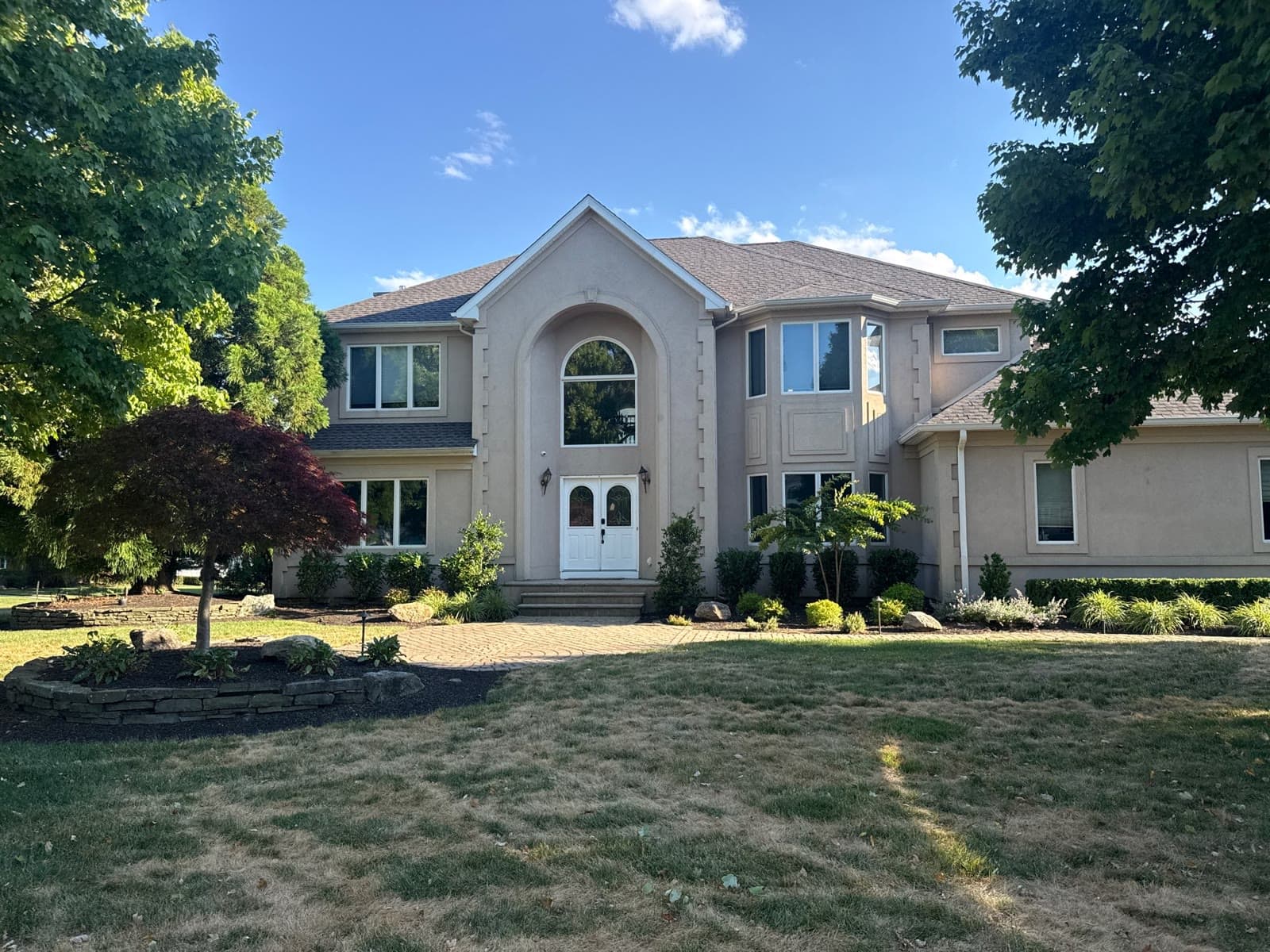 A finished home with a new roof by Green Apple Roofing in New Jersey