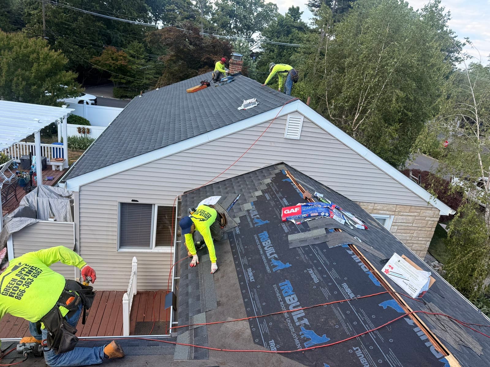 An aerial view of a Green Apple Roofing crew installing a roof in New Jersey