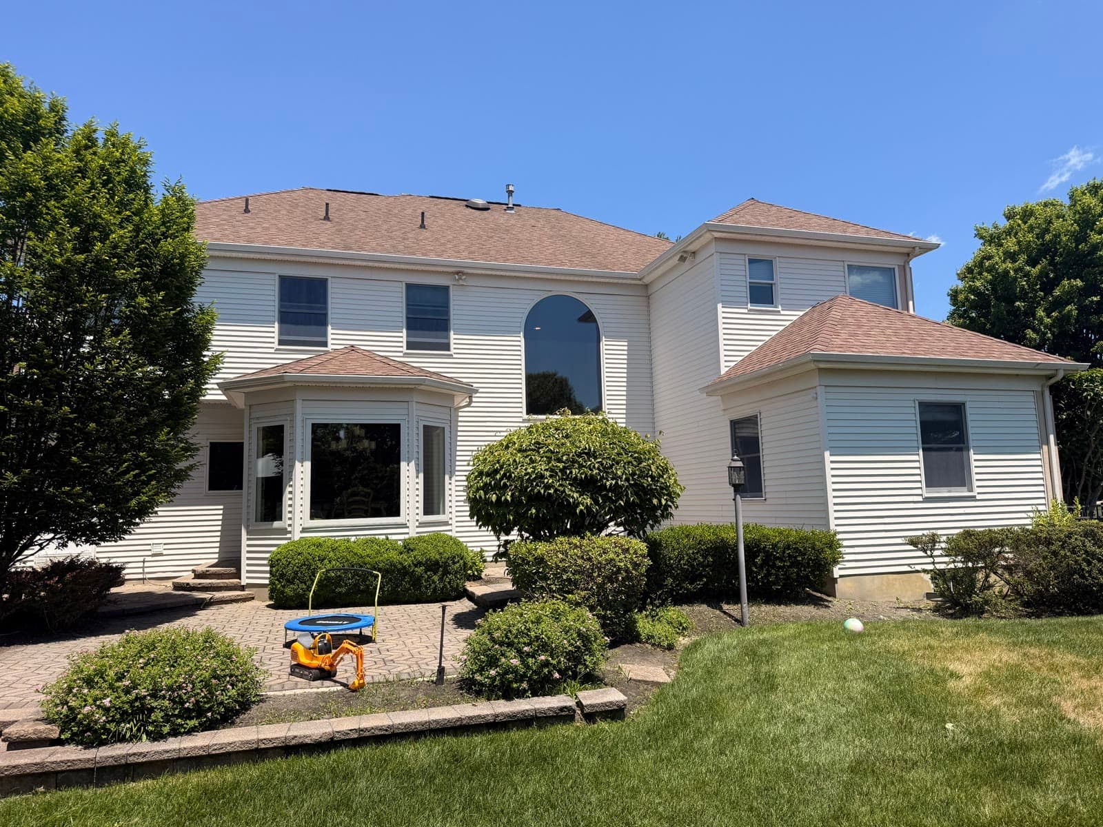 A two-story New Jersey home with a new roof by Green Apple Roofing