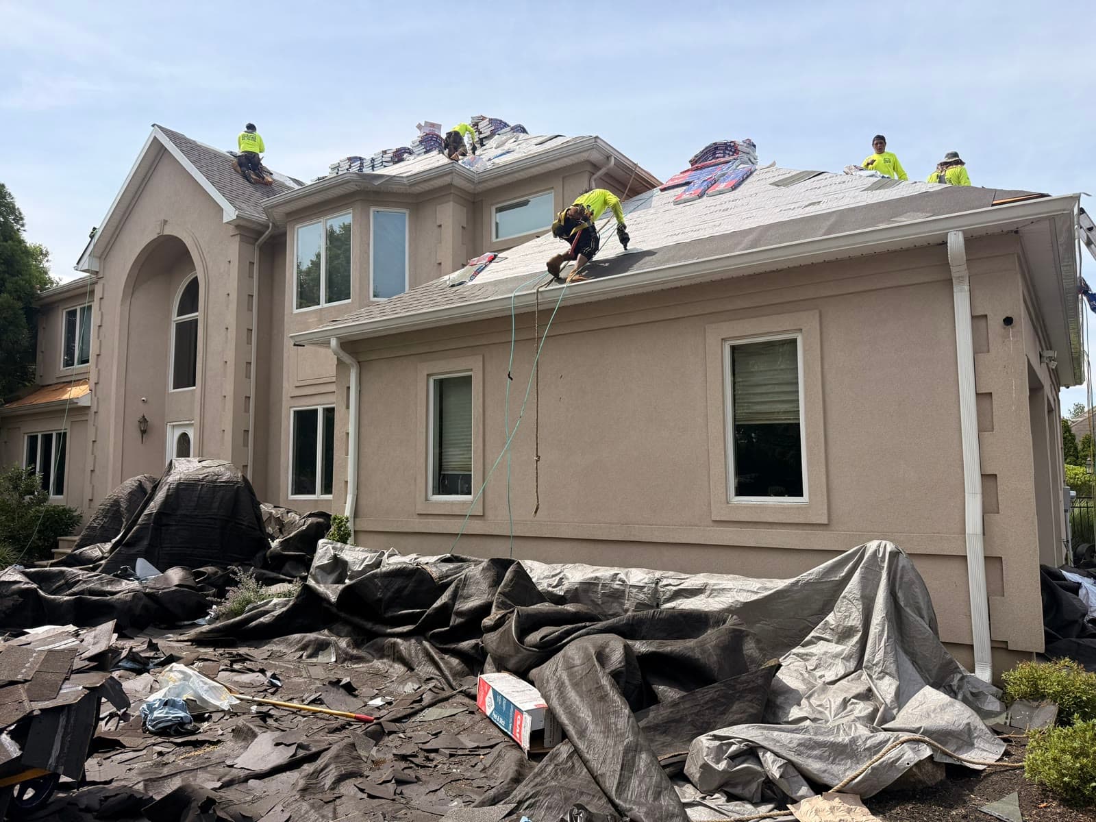 A Green Apple Roofing crew working on a steep New Jersey roof