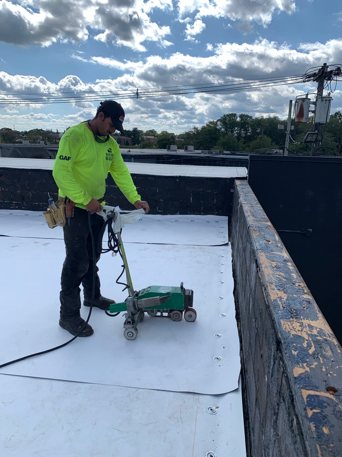A Green Apple crew heat-welding a commercial single-ply membrane roof in New Jersey