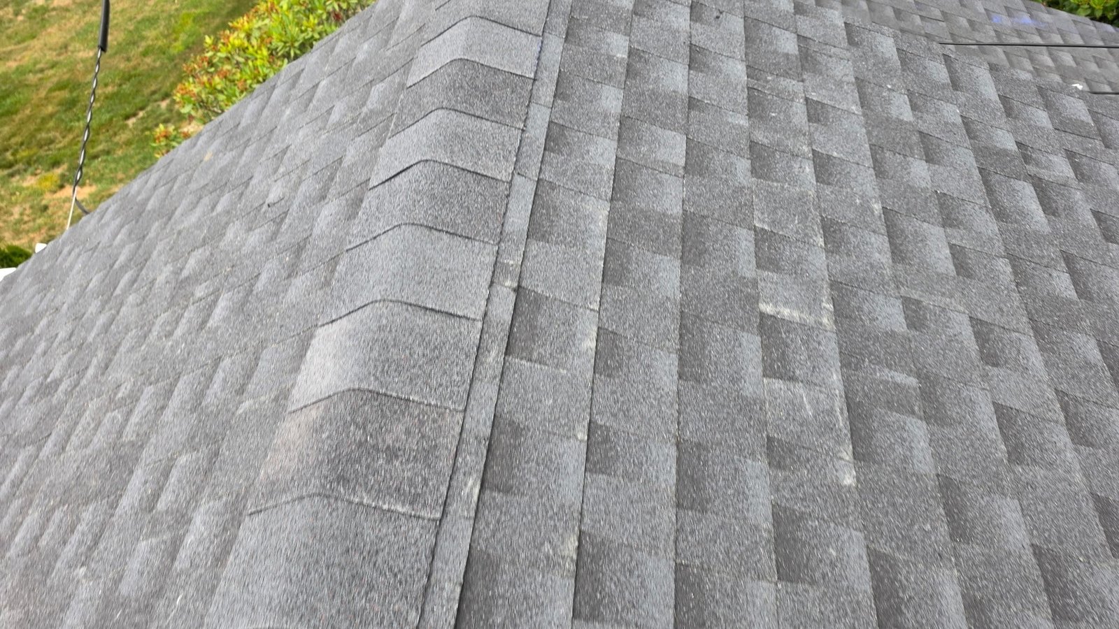 A close-up of a well-installed architectural asphalt shingle roof on a New Jersey home in clear daylight