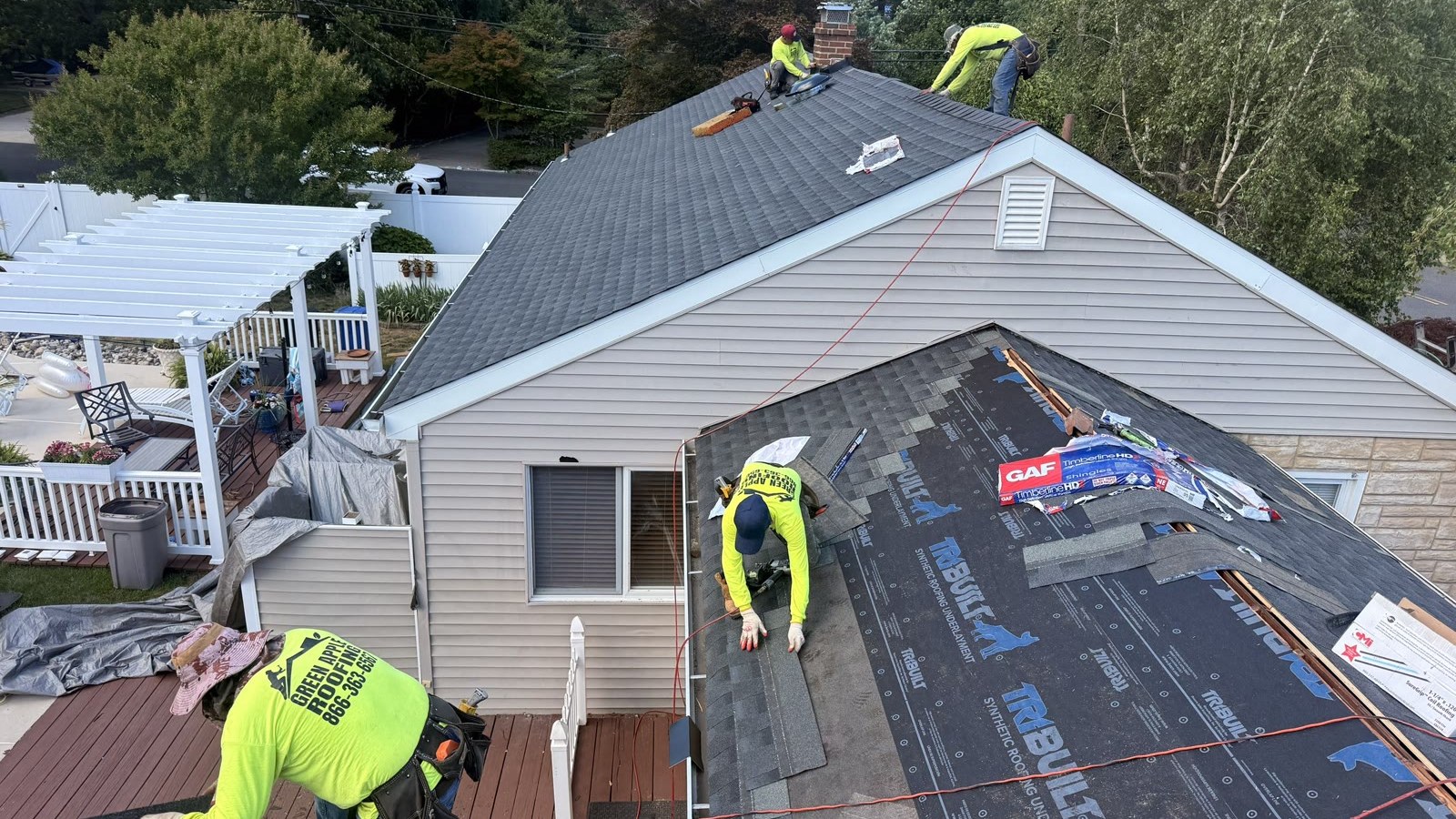 A Green Apple Roofing crew replacing a residential roof in New Jersey — tear-off, GAF underlayment, and new architectural shingles